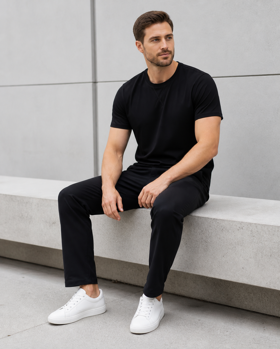Seated model wearing the black Averon Classic Fit tee